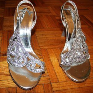 Silver high heeled opened back opened toed shoe